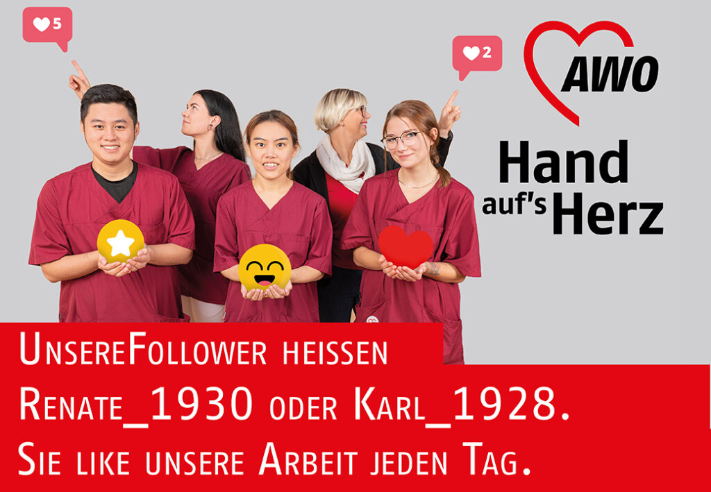 Gruppenfoto von AWO-Mitarbeitern in roter Kleidung, die Schilder mit Emojis und Likes halten.