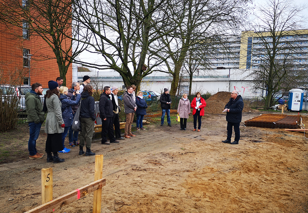 Gruppe von Menschen im Freien bei einer Baustellenbesichtigung
