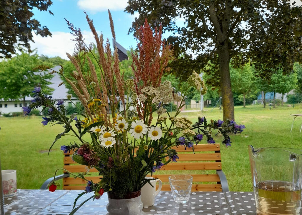 Ein Wildblumenstrau&szlig; auf einem Tisch im Freien.