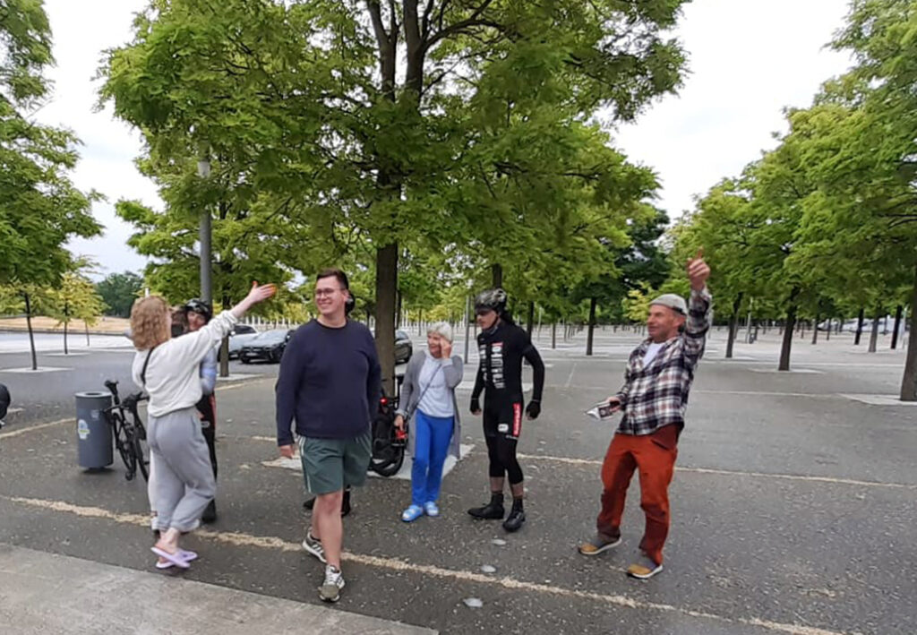 Gruppe von Menschen steht im Freien unter B&auml;umen