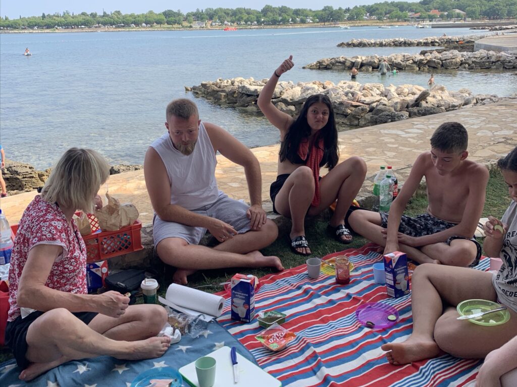 Gruppe beim Picknick am Meer