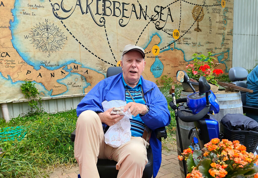 Mann sitzt vor einer Karte der Karibik