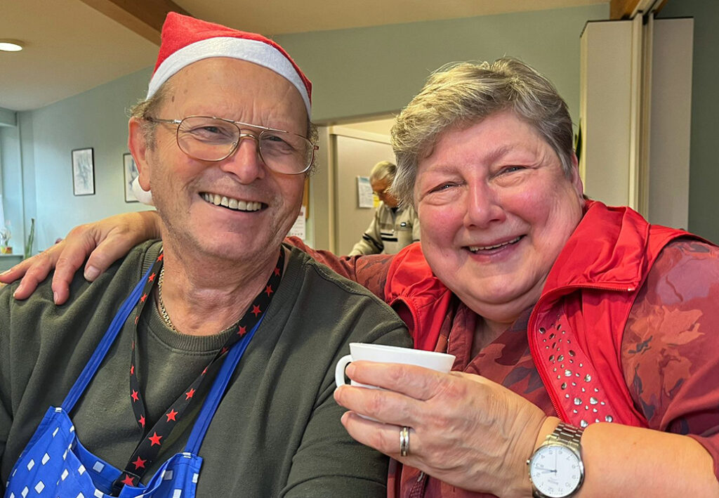 Ein &auml;lterer Mann und eine &auml;ltere Frau l&auml;cheln in die Kamera, der Mann tr&auml;gt eine Nikolausm&uuml;tze.