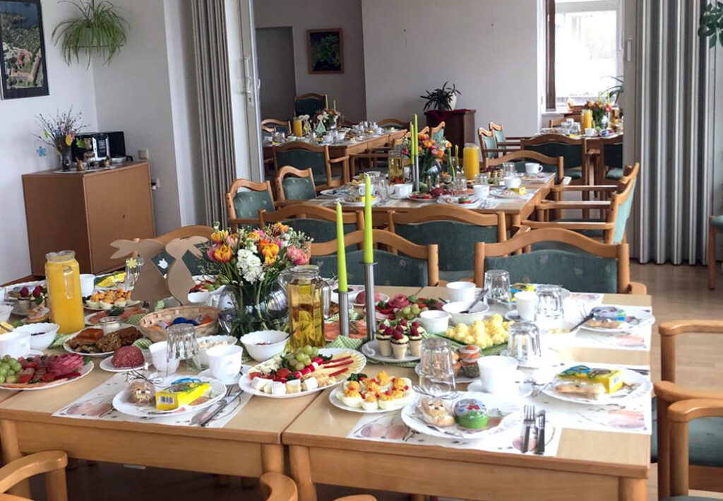 Festlich gedeckter Tisch in einem Raum mit St&uuml;hlen und Dekoration