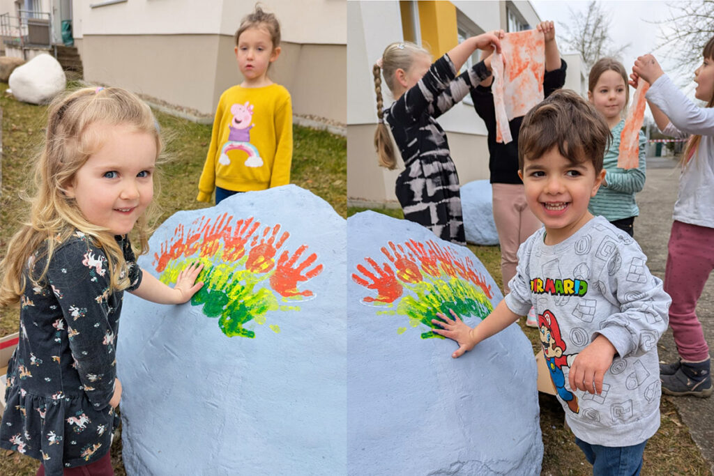 Kinder bemalen einen Stein mit bunten Handabdr&uuml;cken
