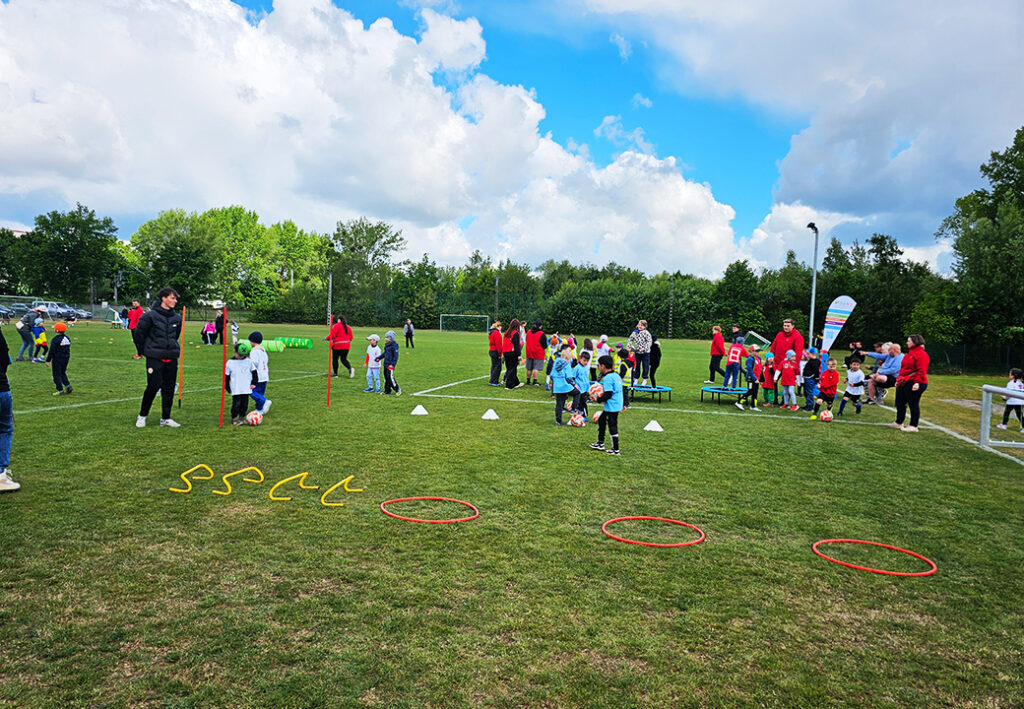 Kinder auf einem Sportplatz bei einem Event mit Betreuern