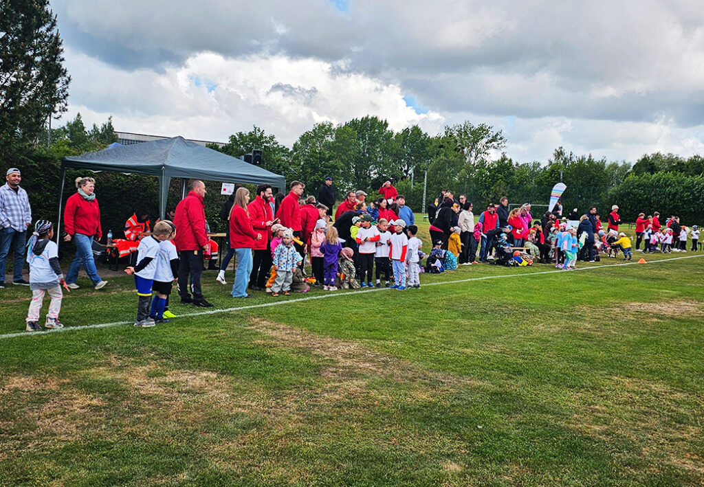 Menschenmenge bei einem Sportfeld.
