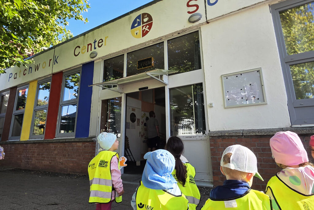 Kinder vor einem Patchwork Center Geb&auml;ude