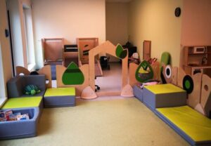 Innenraum eines Kindergartens oder Spielzimmers mit bunten Möbeln.