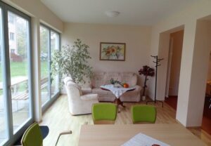 Wohnzimmer mit Sitzgruppe und Fenstern